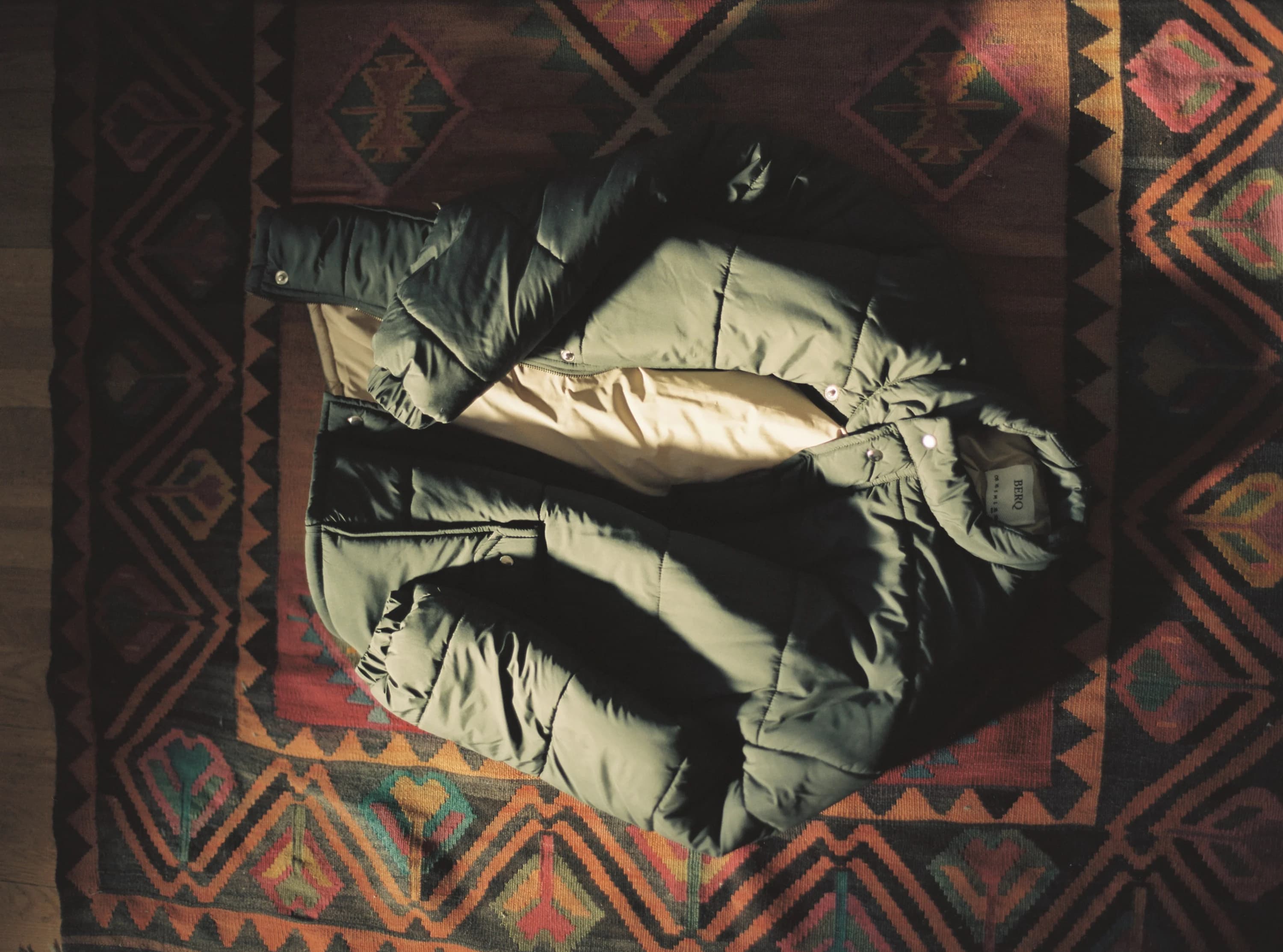 BERQ padded jacket photographed on a patterned rug
